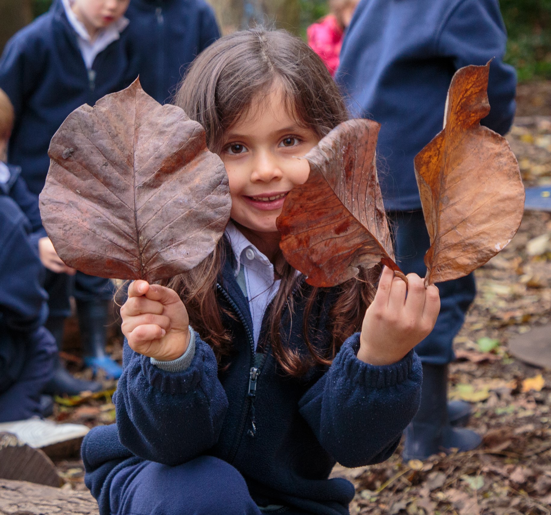 Child and big leaves