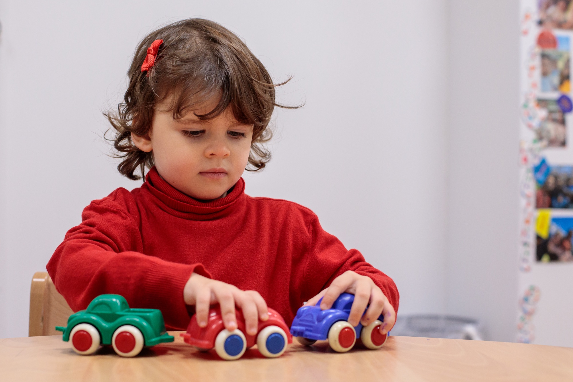 child playing with toy cars