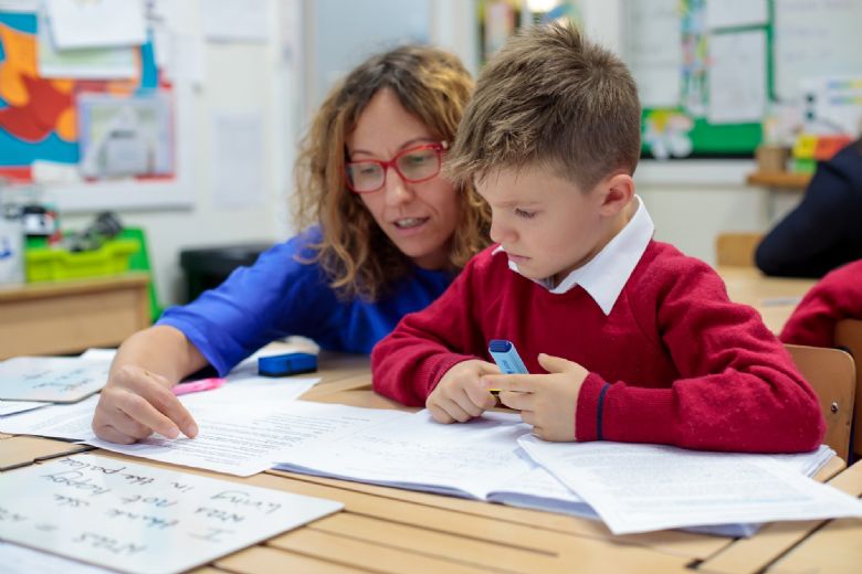 Teacher helping child